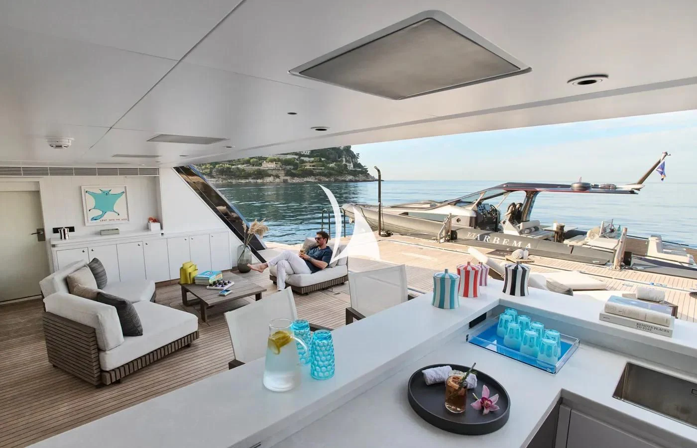 a room with a couch and a table with a tray of food on it aboard ARBEMA Yacht for Sale