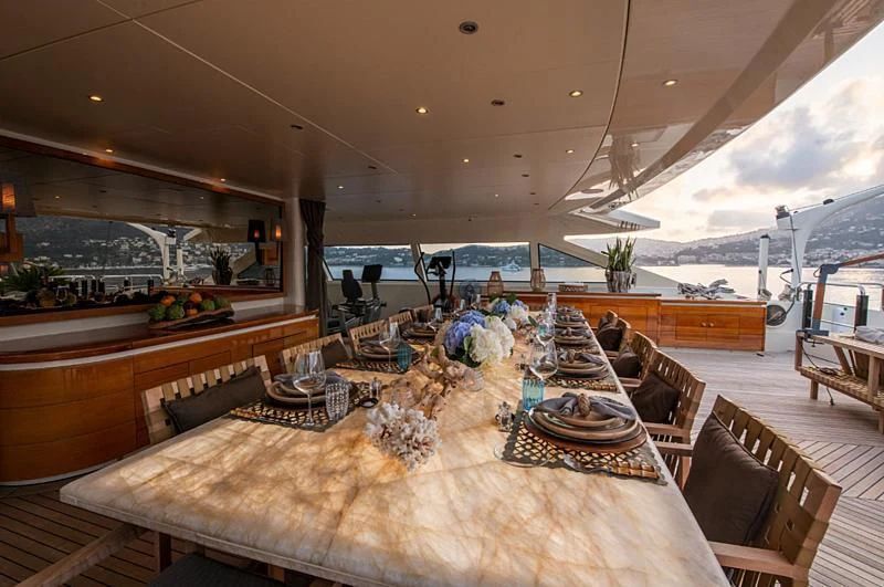 a large room with a table and chairs aboard ARBEMA Yacht for Sale