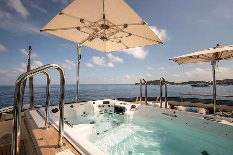 a pool with an umbrella aboard ARBEMA Yacht for Sale