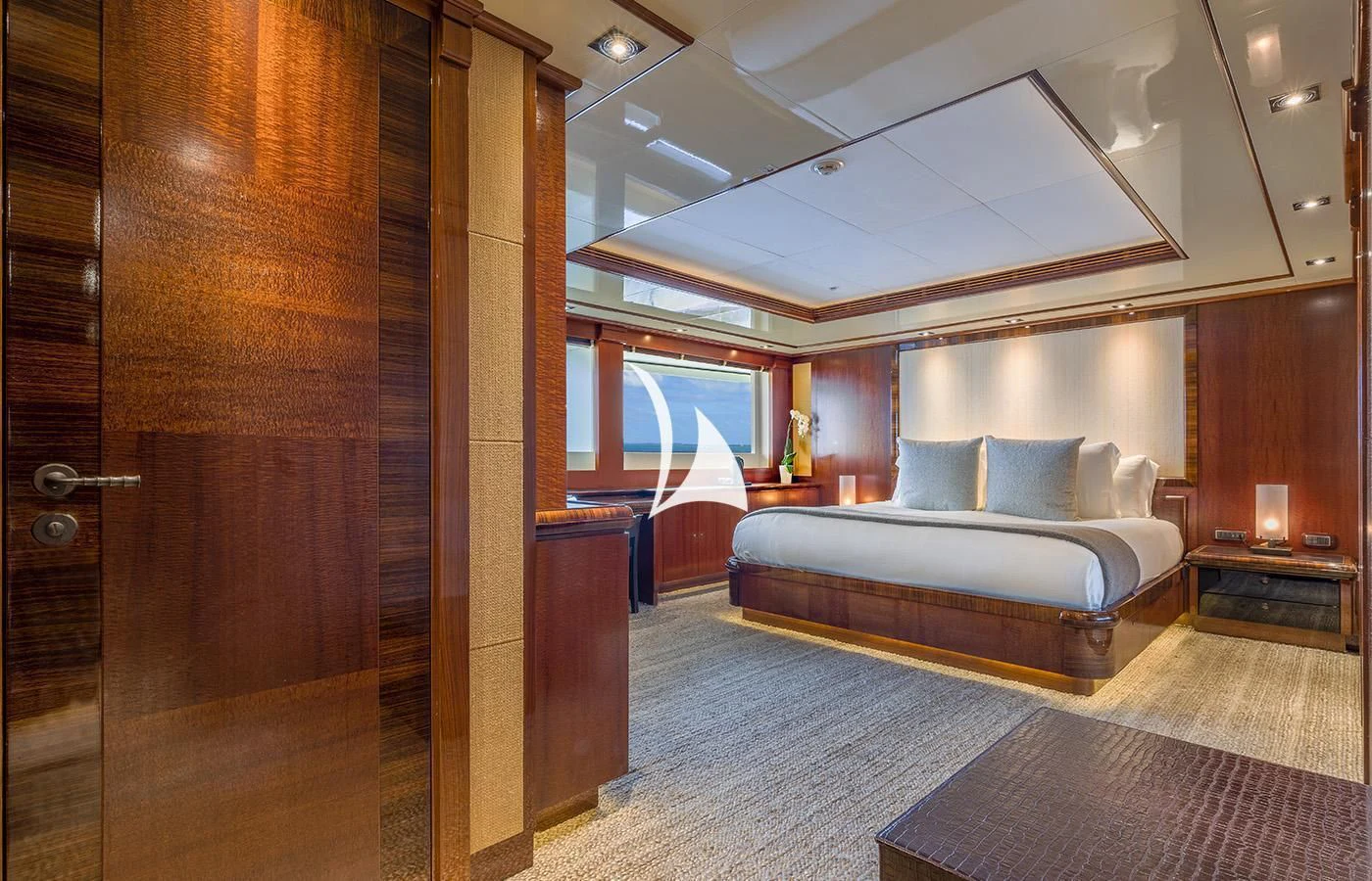 a bedroom with a bed and a large mirror aboard ARBEMA Yacht for Sale