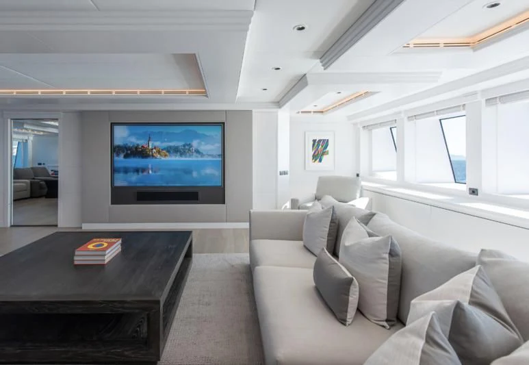 a living room with a large screen aboard ARBEMA Yacht for Sale