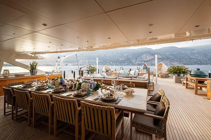 a room with tables and chairs aboard ARBEMA Yacht for Sale