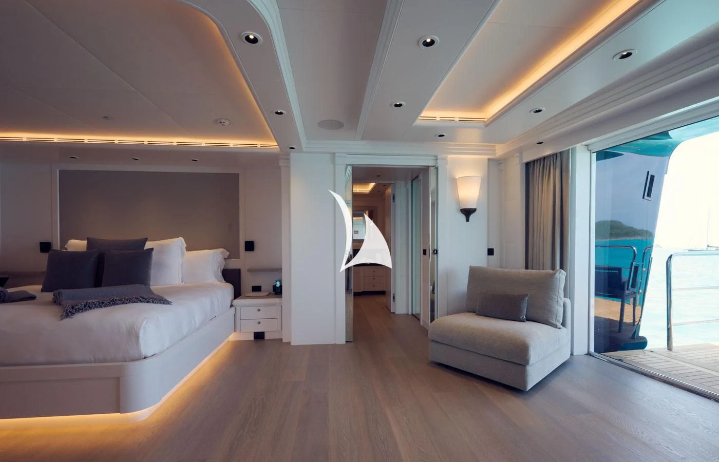 a bedroom with a bed and a chair aboard ARBEMA Yacht for Sale