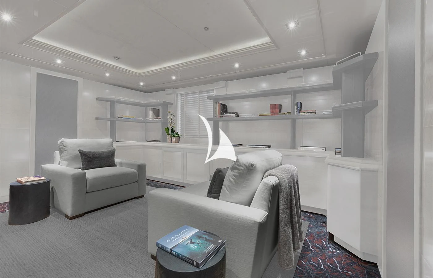 a room with a couch and a shelf with books on it aboard ARBEMA Yacht for Sale
