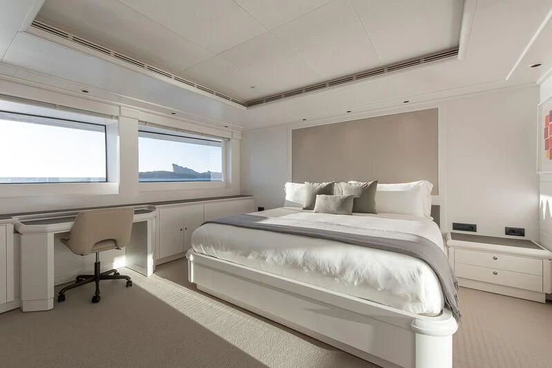 a bedroom with a bed and desk aboard ARBEMA Yacht for Sale