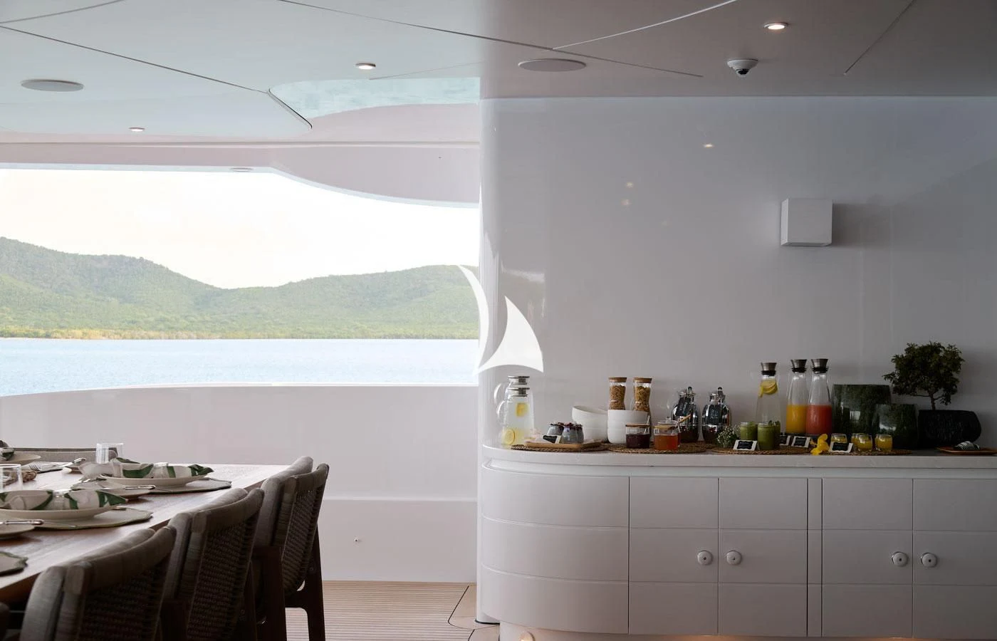 a kitchen with a view of the ocean and mountains aboard ARBEMA Yacht for Sale