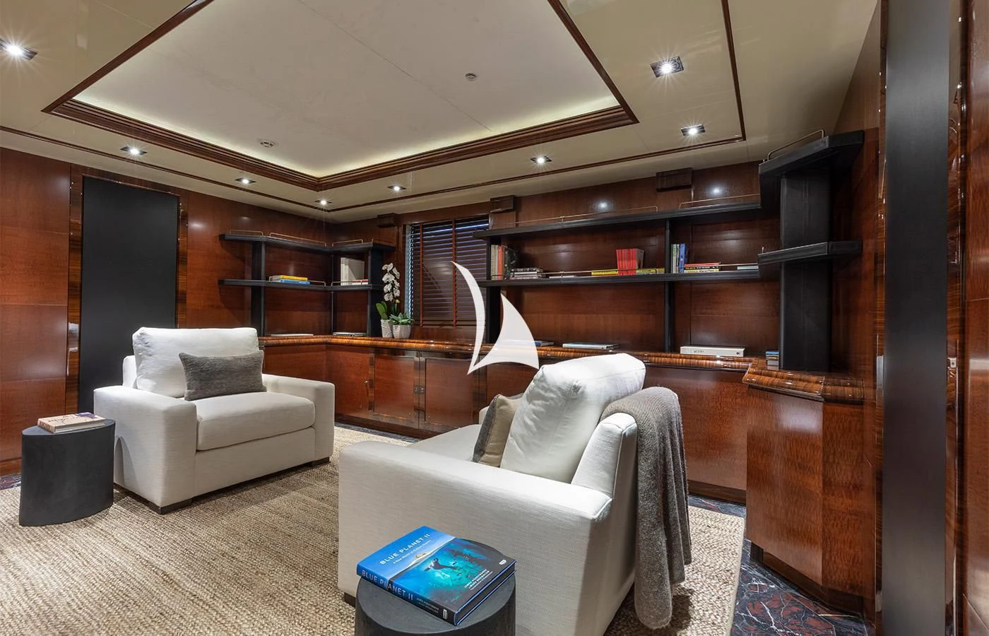 a room with a couch and a shelf with books aboard ARBEMA Yacht for Sale