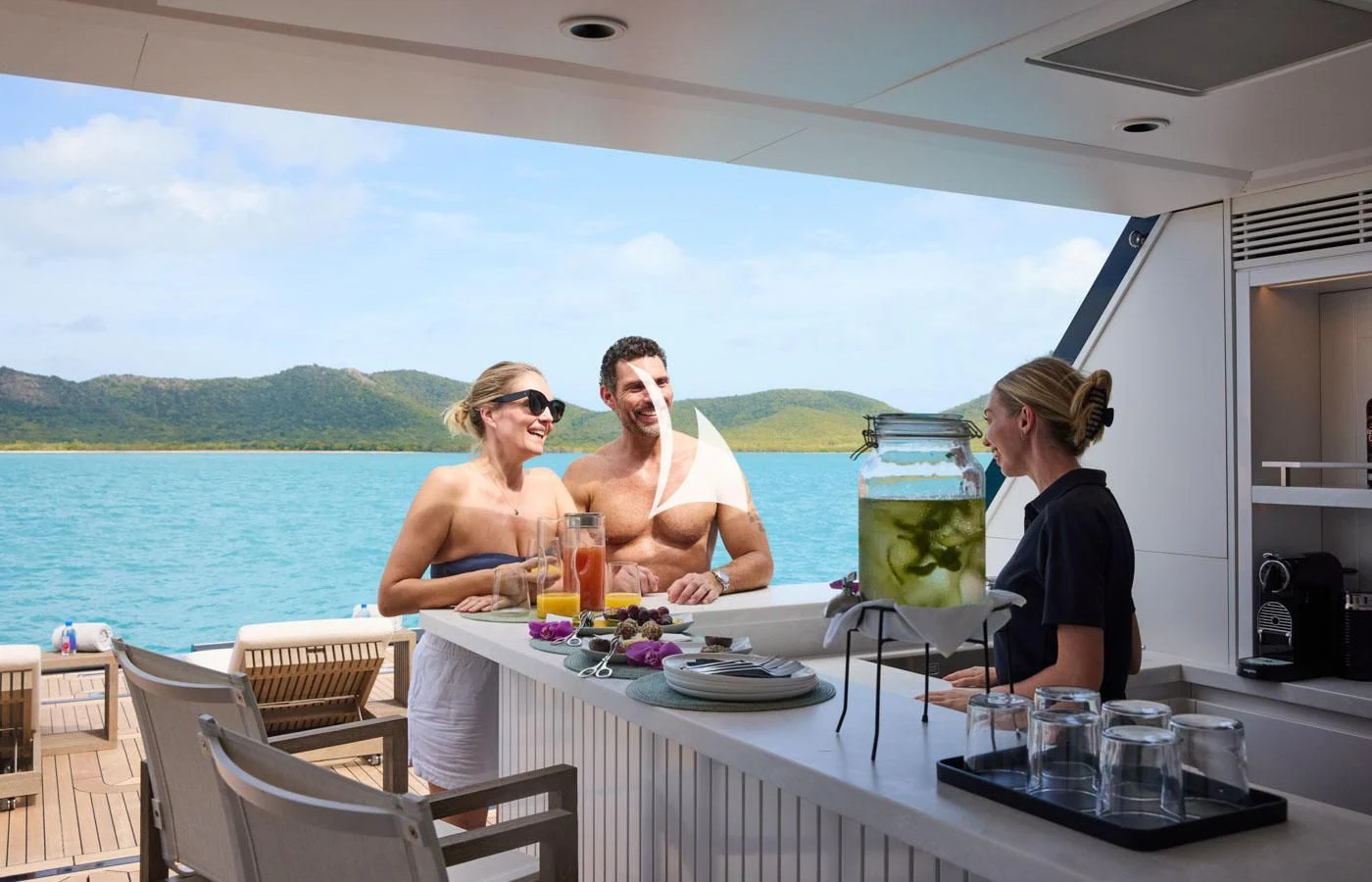 a group of people sitting at a table outside on a boat aboard ARBEMA Yacht for Sale