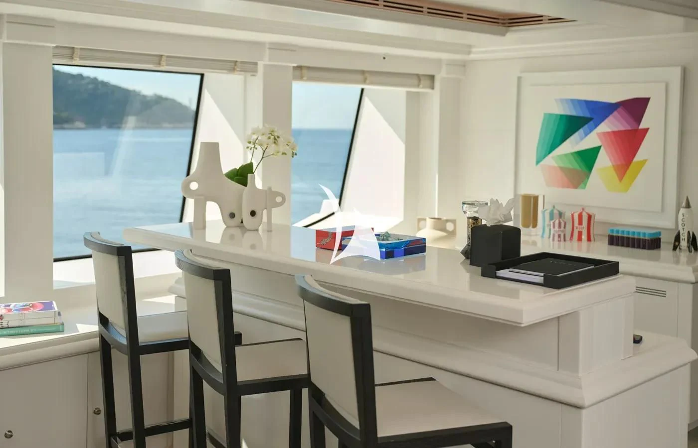 a white desk with a black chair and white cabinets aboard ARBEMA Yacht for Sale