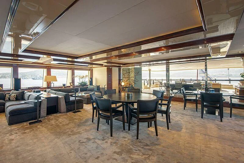 a large room with a table and chairs aboard ARBEMA Yacht for Sale