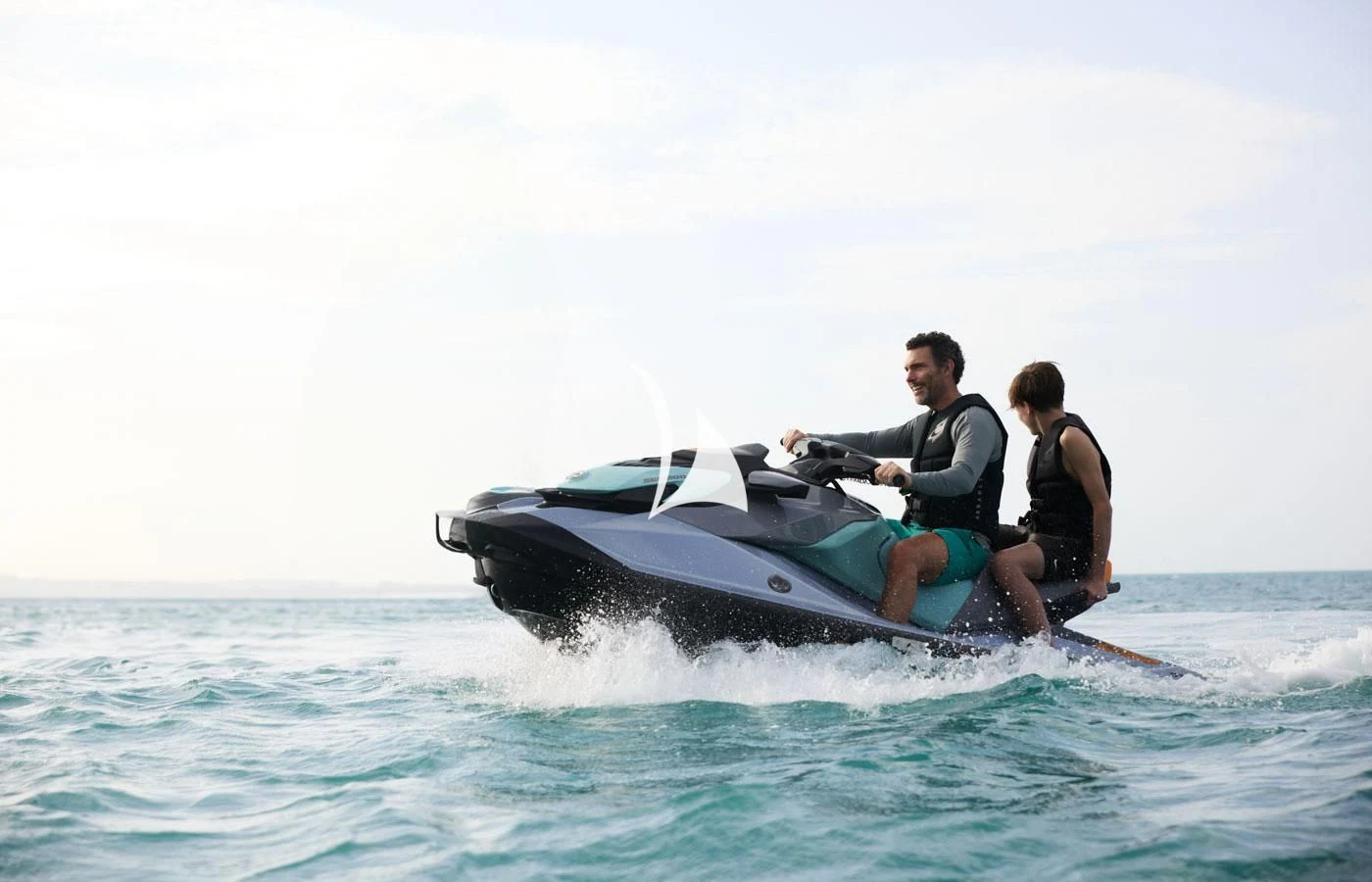 a man and a woman on a jet ski in the ocean aboard ARBEMA Yacht for Sale