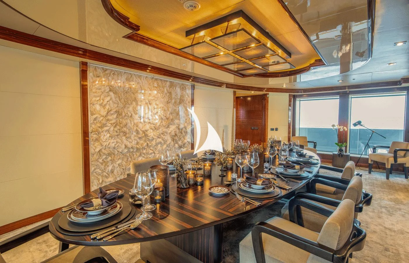 a large dining table with chairs and a large window aboard ARBEMA Yacht for Sale