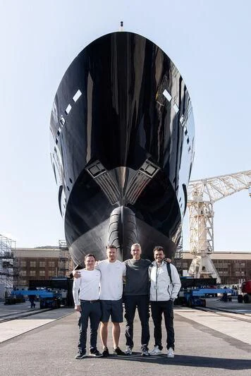 a group of people standing in front of a large sculpture aboard ARBEMA Yacht for Sale