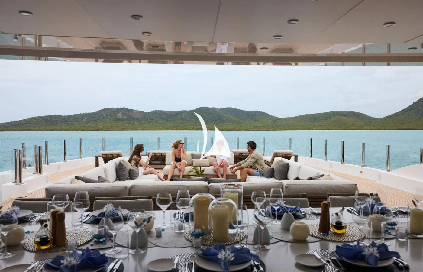 a group of people sitting on a couch on a beach aboard ARBEMA Yacht for Sale