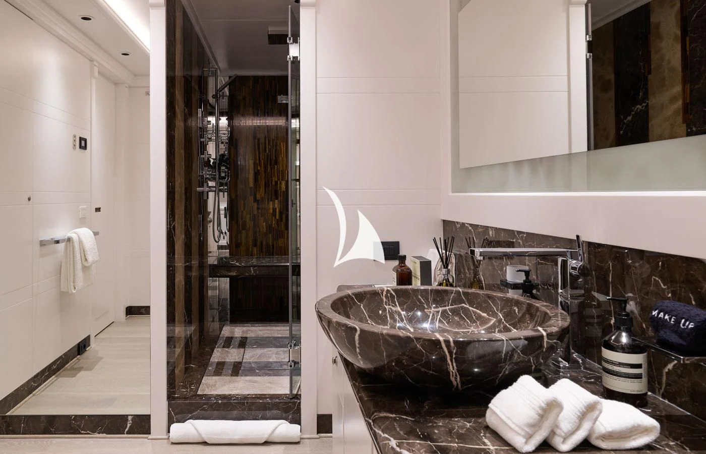 a bathroom with a sink and a large mirror aboard ARBEMA Yacht for Sale
