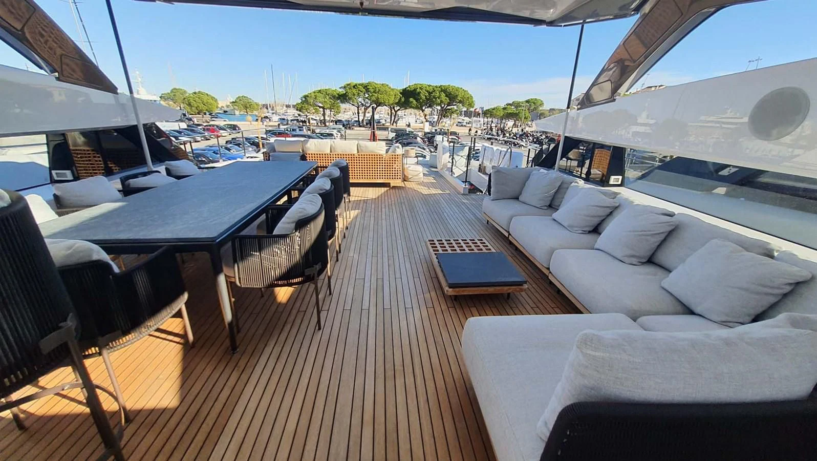 a deck with a table and chairs aboard AMORES Yacht for Sale