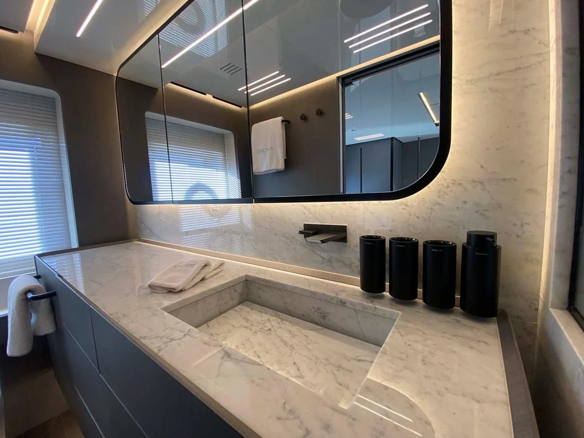 a bathroom with a large mirror aboard AMORES Yacht for Sale