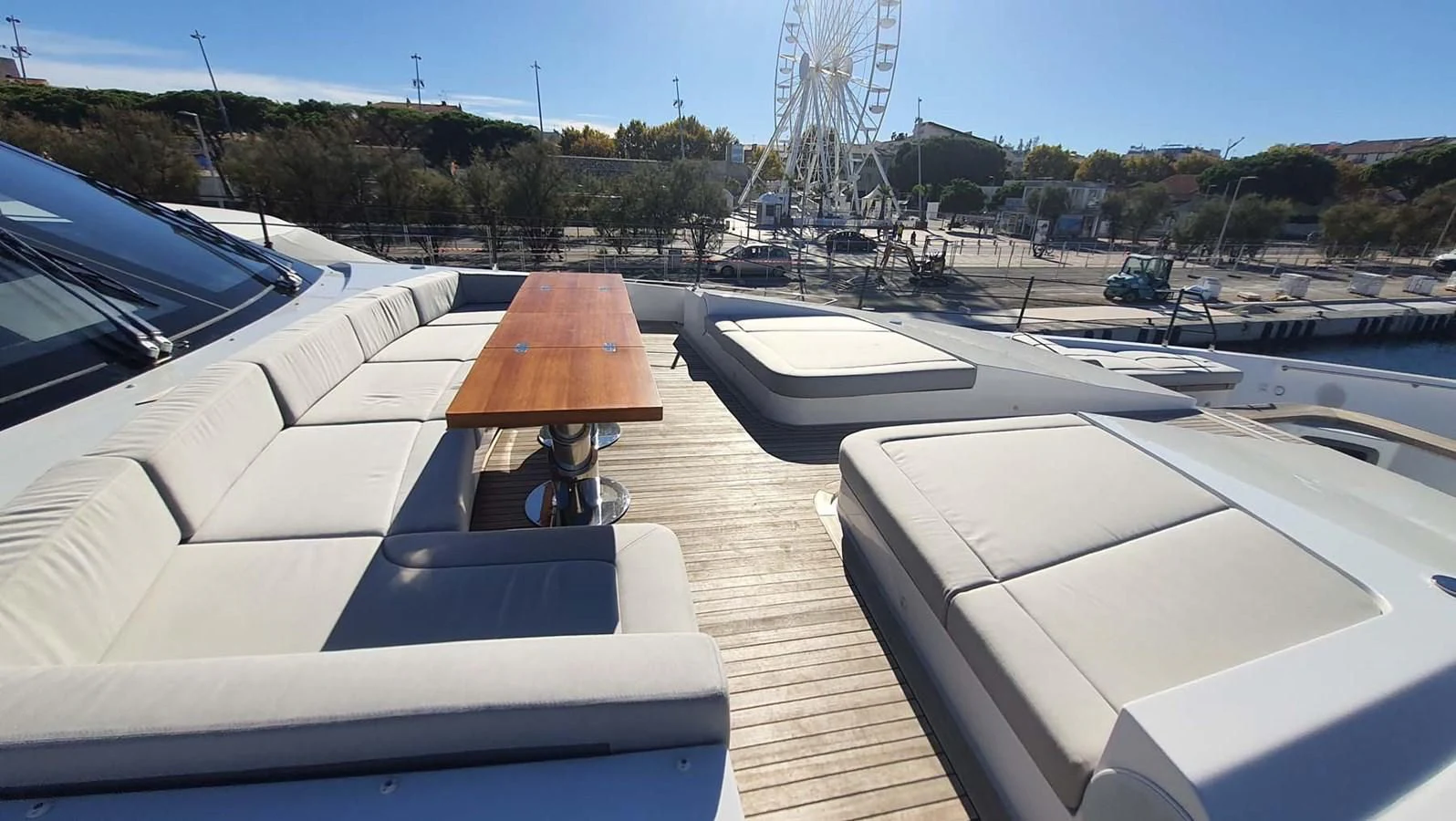 a deck with a water slide and a roller coaster in the background aboard AMORES Yacht for Sale