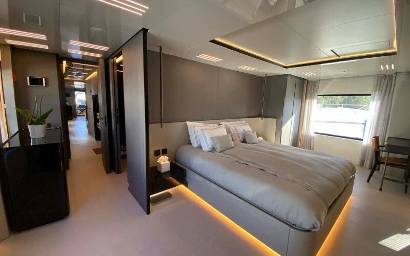 a room with a bed and a window aboard AMORES Yacht for Sale