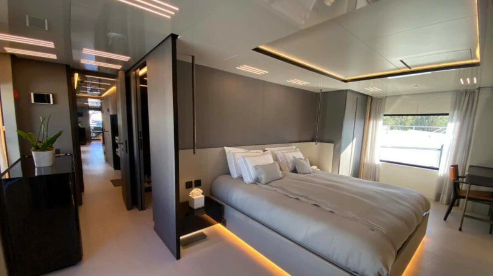 a bedroom with a bed and a window aboard AMORES Yacht for Sale