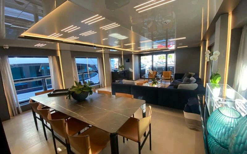 a room with a table and chairs aboard AMORES Yacht for Sale