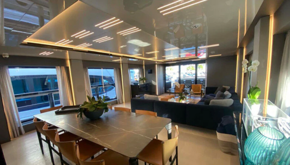 a room with a table and chairs aboard AMORES Yacht for Sale