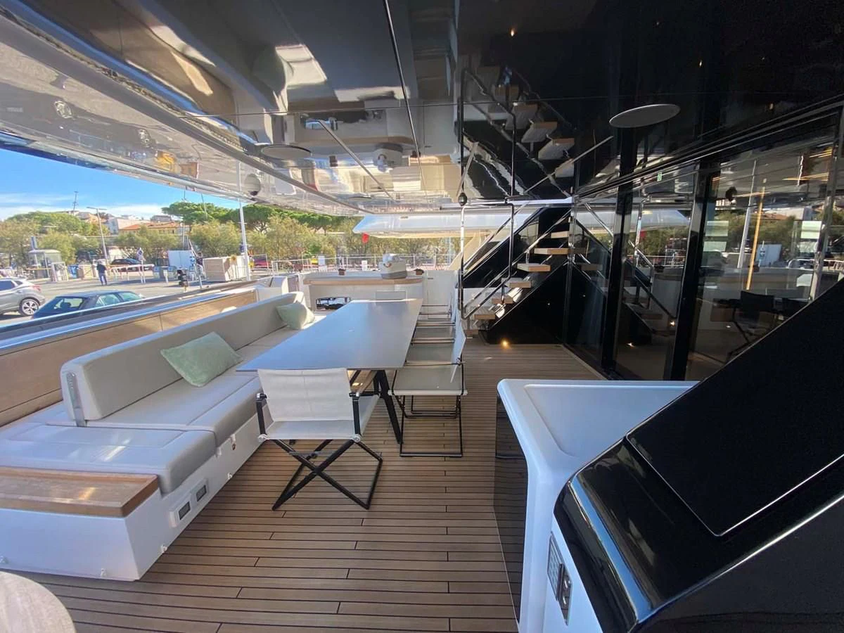 a room with a bed and a table and chairs aboard AMORES Yacht for Sale