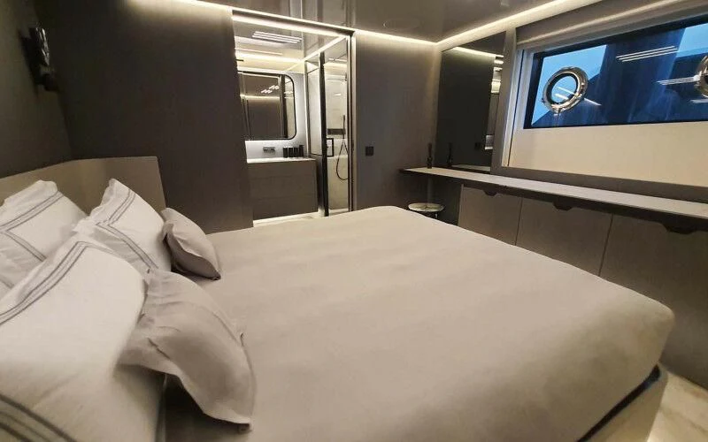 a room with two beds aboard AMORES Yacht for Sale