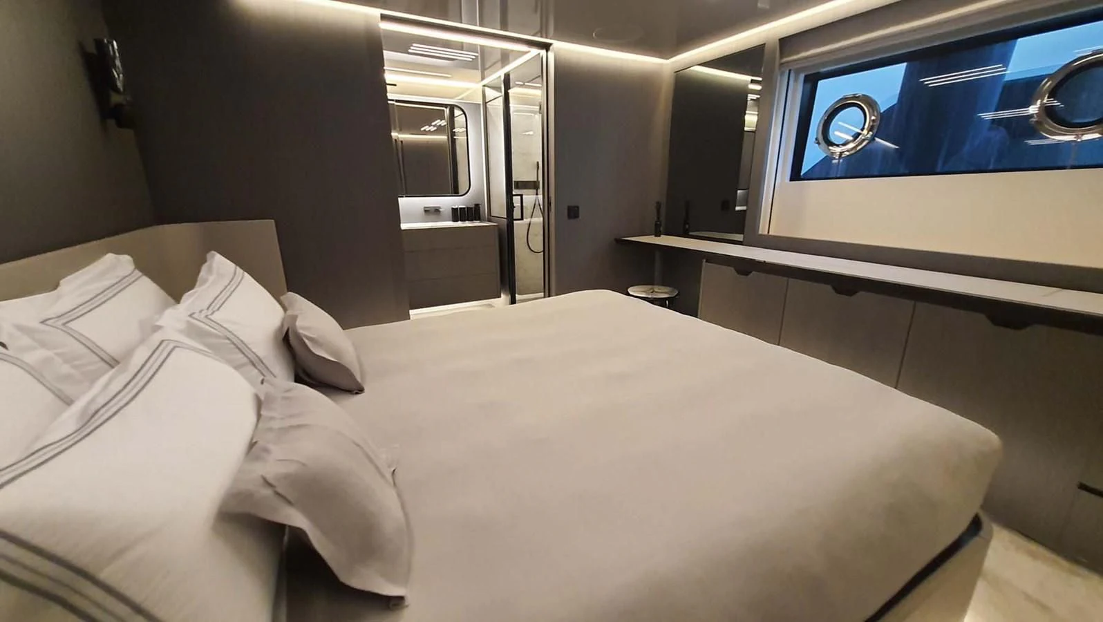a bed with white sheets aboard AMORES Yacht for Sale