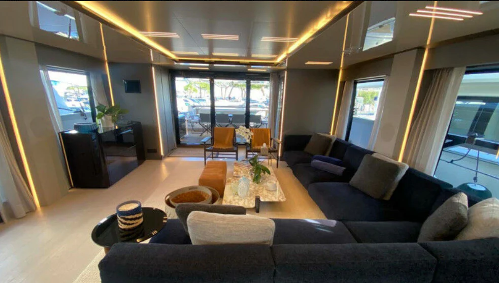 a living room with a large window aboard AMORES Yacht for Sale