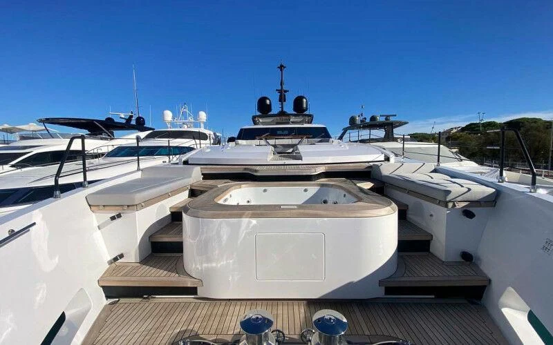 a large white ship with a large ship in the background aboard AMORES Yacht for Sale
