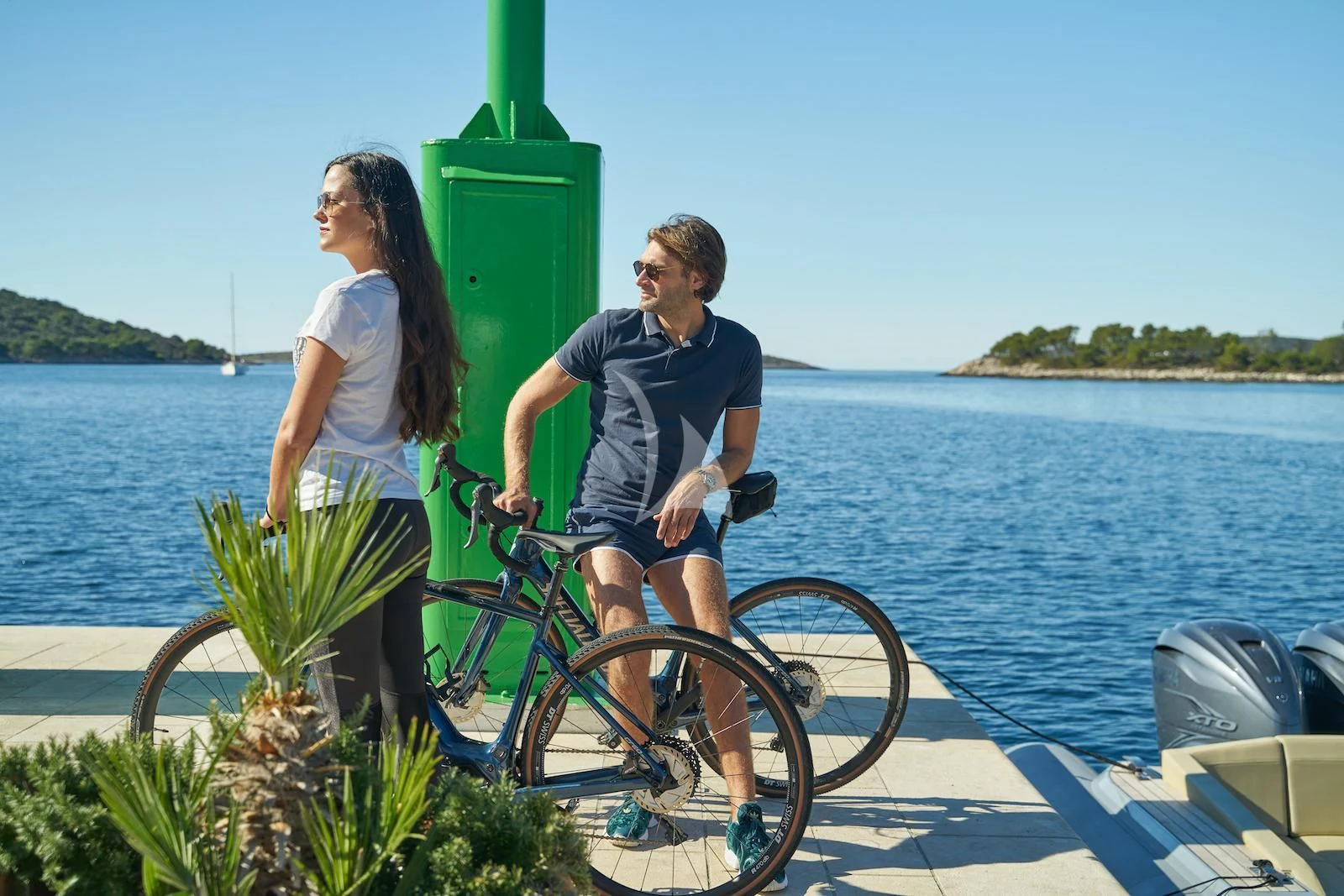 a man and woman on a bicycle aboard HAPPY ME Yacht for Charter