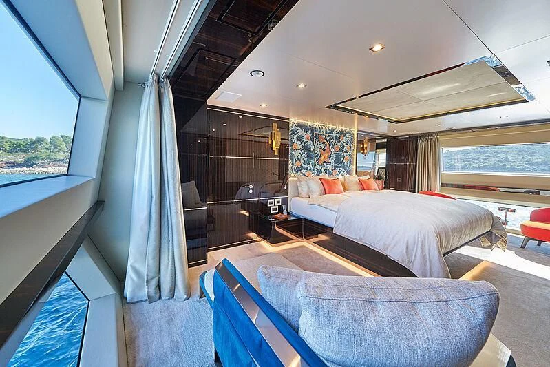 a room with a bed and a large window aboard HAPPY ME Yacht for Charter