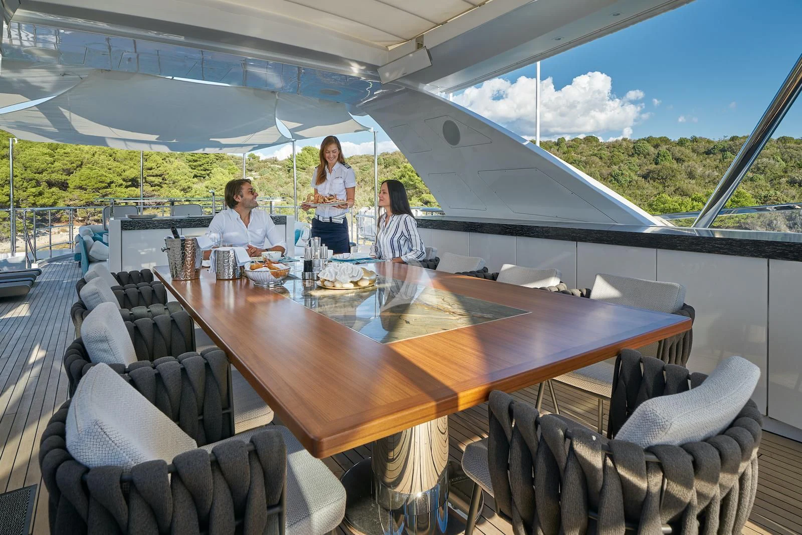 people sitting at a table aboard HAPPY ME Yacht for Charter
