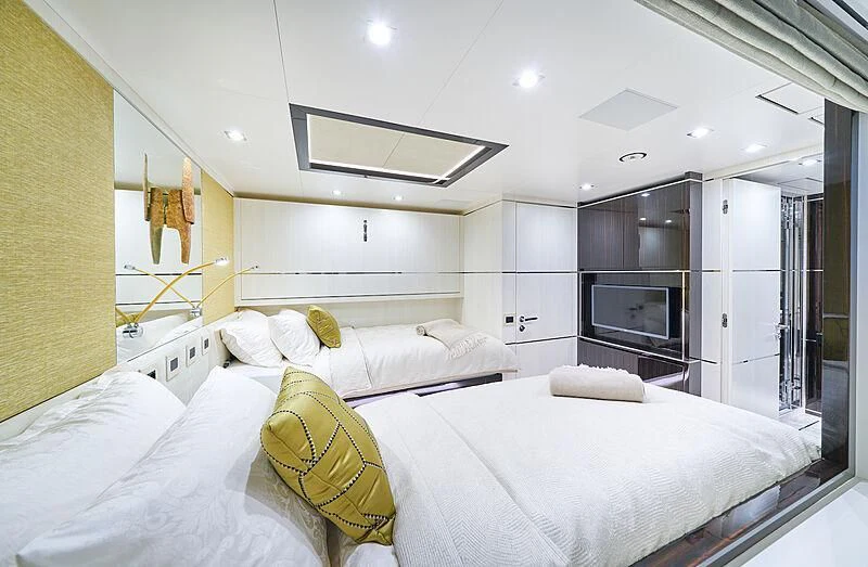 a bedroom with a bed and a television aboard HAPPY ME Yacht for Charter