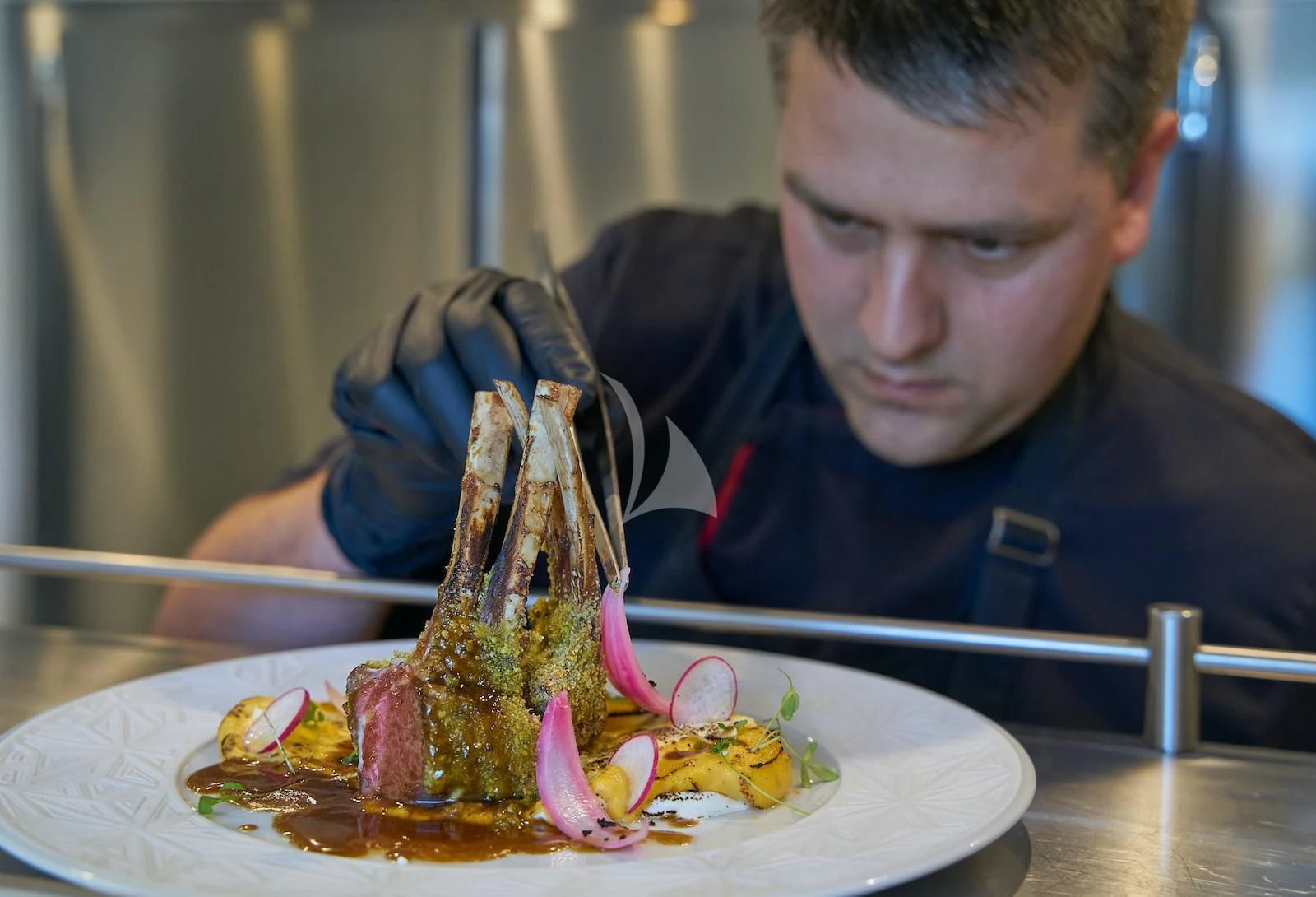 a person holding a knife to a piece of meat on a plate aboard HAPPY ME Yacht for Charter