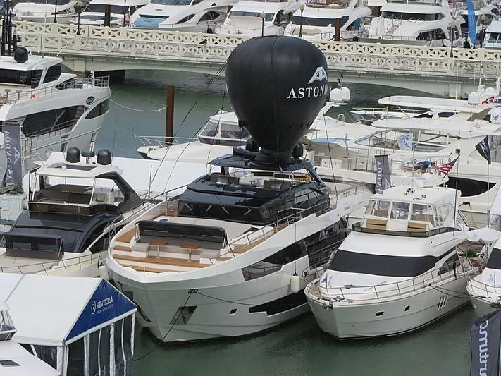 a large black balloon tied to a boat in a harbor aboard MR DOOM Yacht for Sale