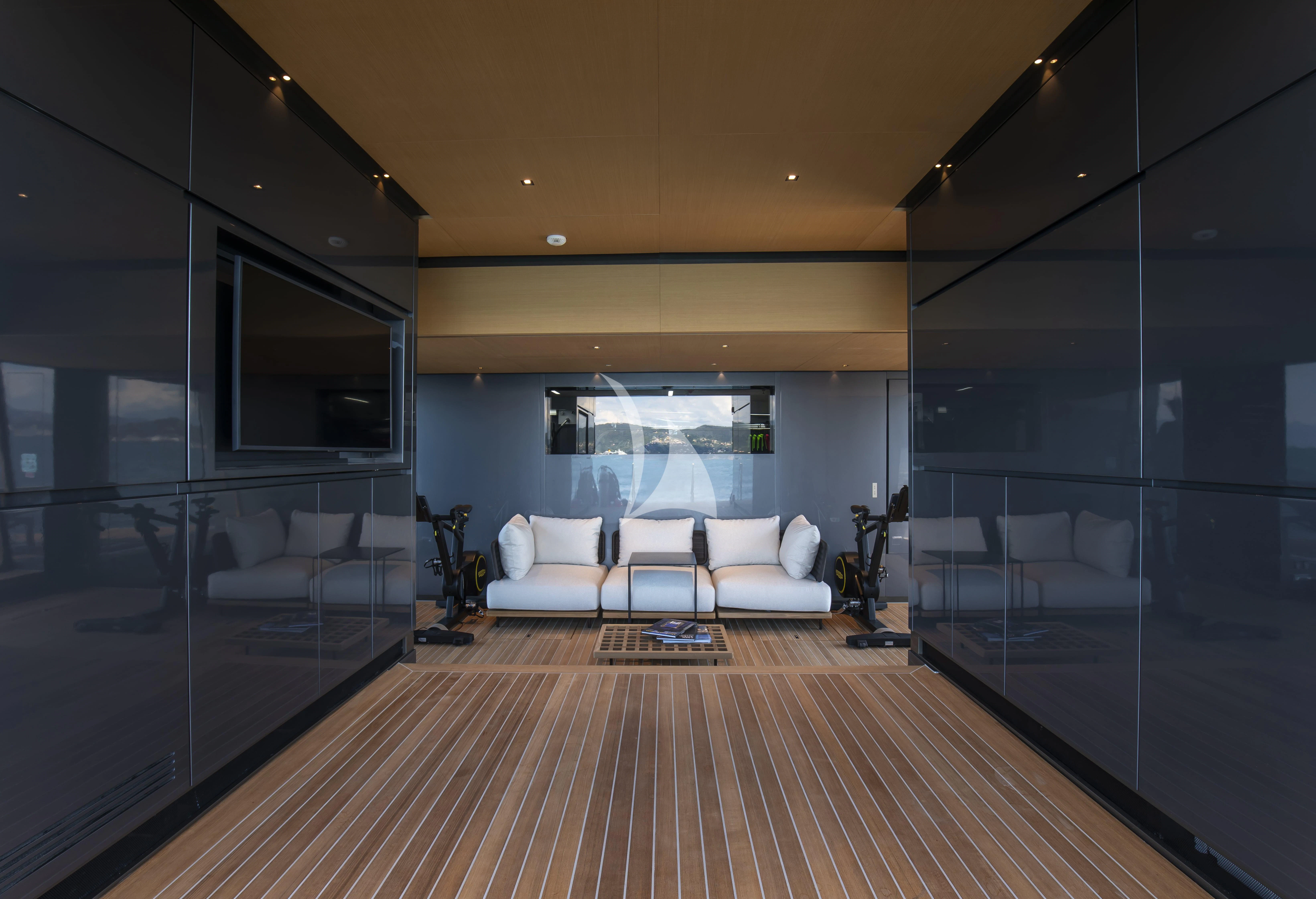 a living room with a large wood floor aboard PANAM Yacht for Sale
