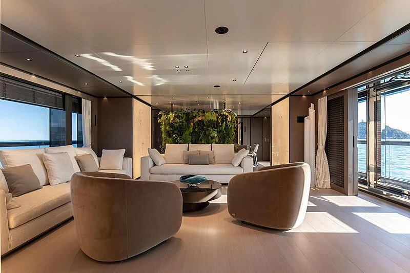 a living room with couches and a table aboard PANAM Yacht for Sale
