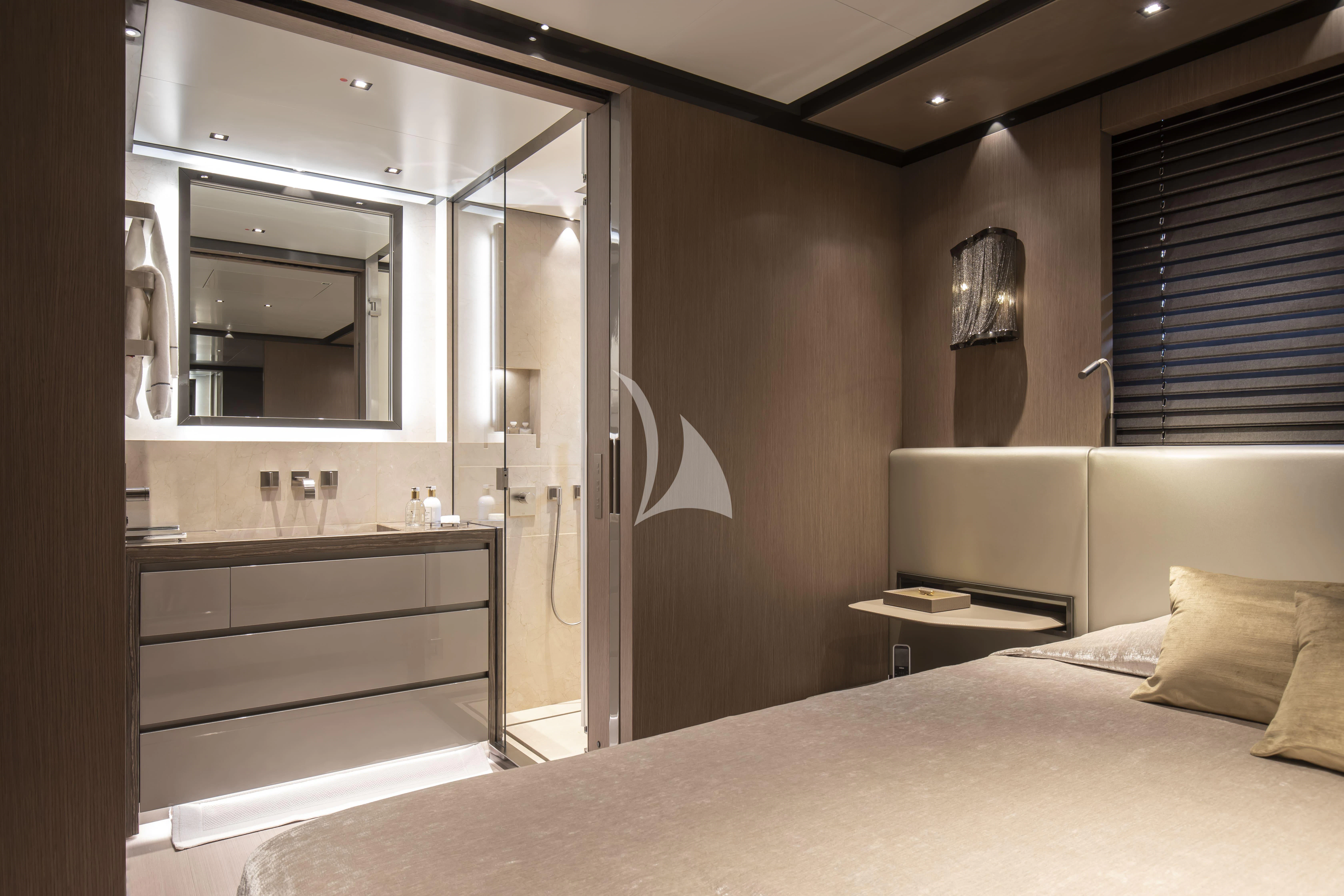a bedroom with a bed and a mirror aboard PANAM Yacht for Sale