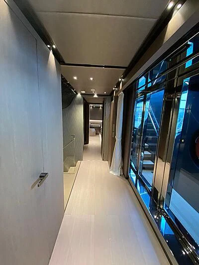 a hallway with glass doors aboard PANAM Yacht for Sale