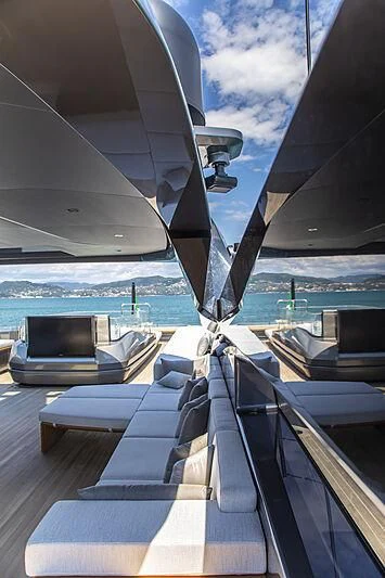 a deck with a view of the ocean and a boat aboard PANAM Yacht for Sale