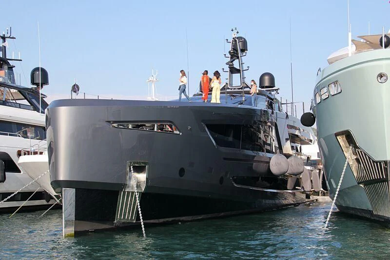 a group of people standing on a boat in the water aboard PANAM Yacht for Sale