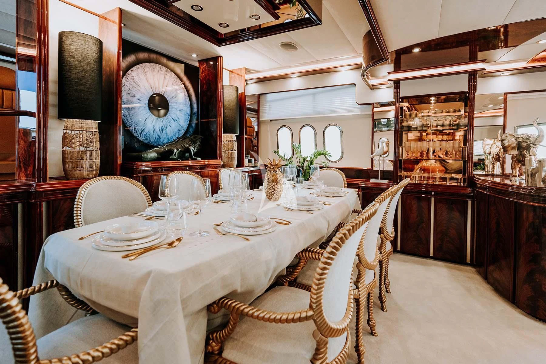a dining room with a table set aboard SONRISA SEPTIMO Yacht for Sale