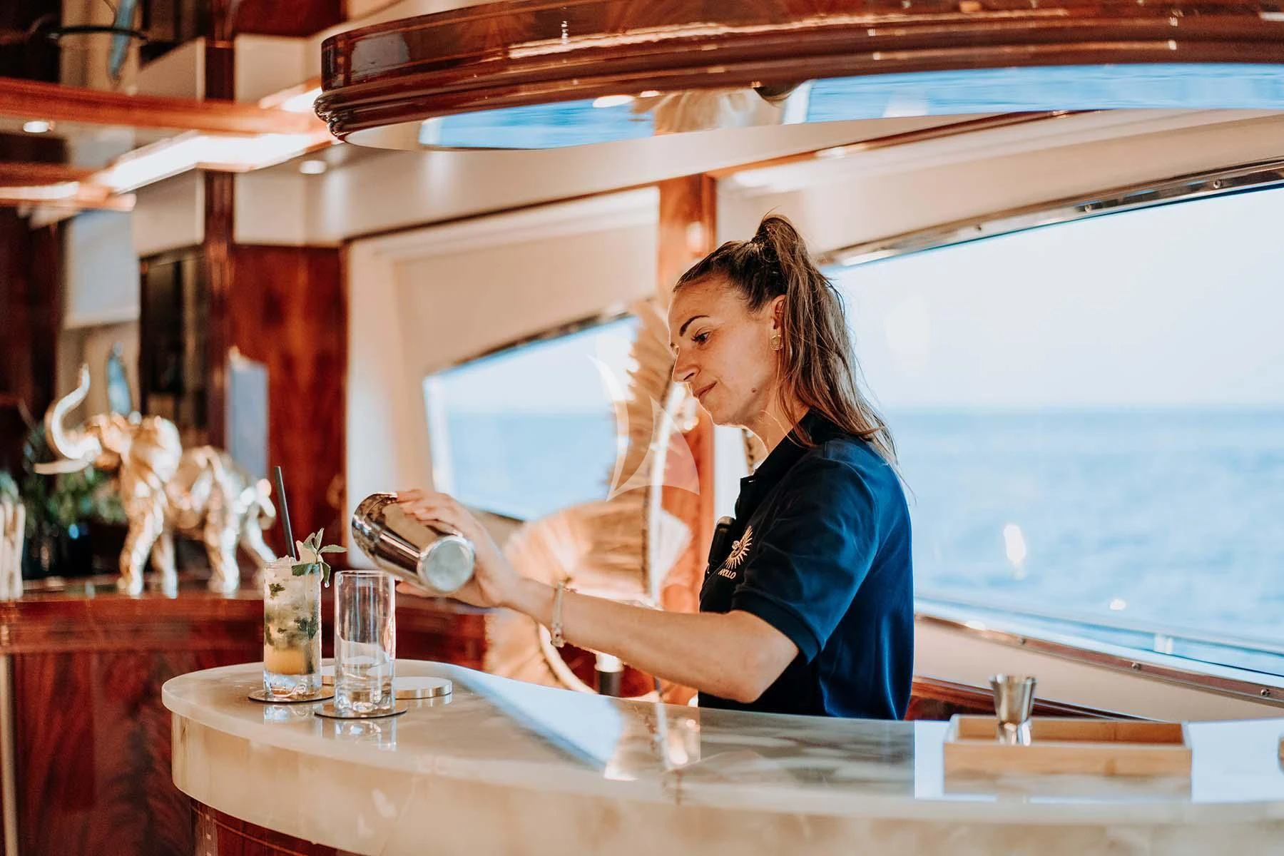 a person pouring liquid into a glass aboard SONRISA SEPTIMO Yacht for Sale