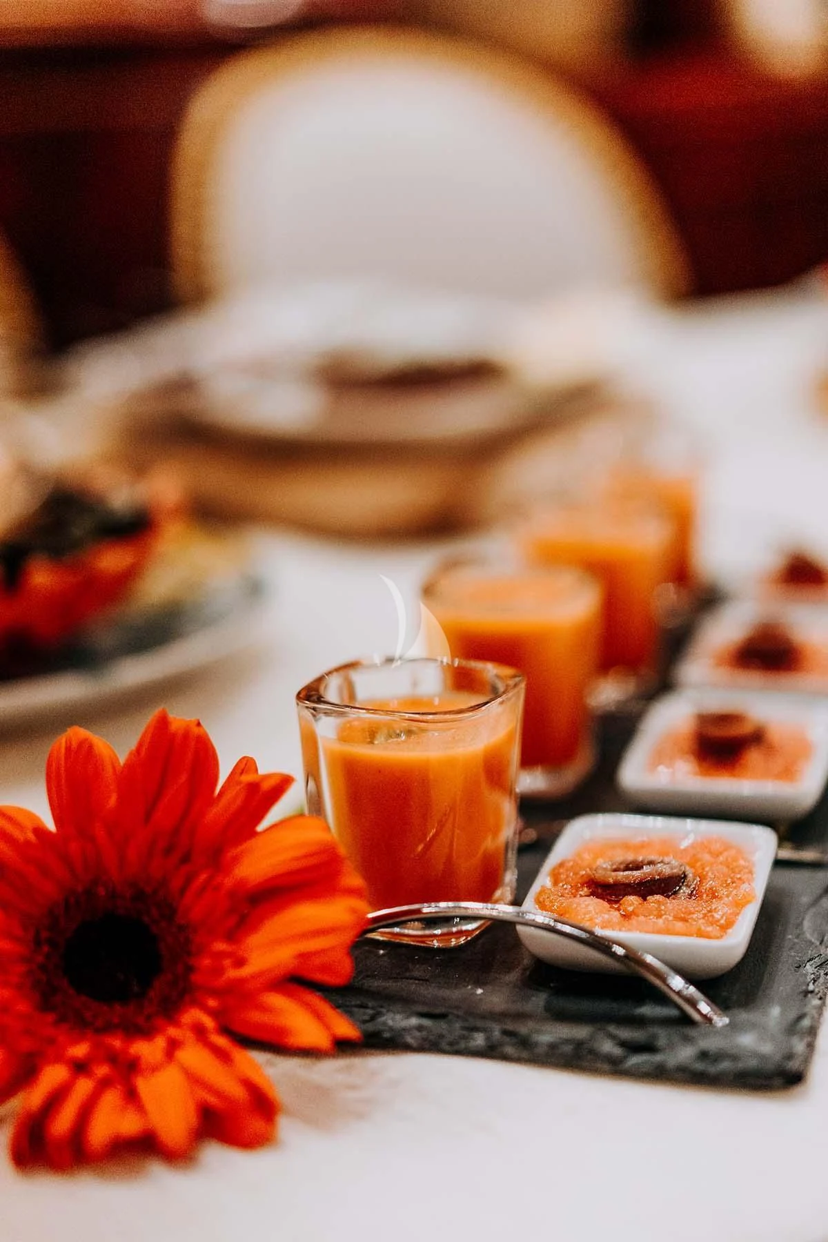 a table with food and a vase with a flower aboard SONRISA SEPTIMO Yacht for Sale