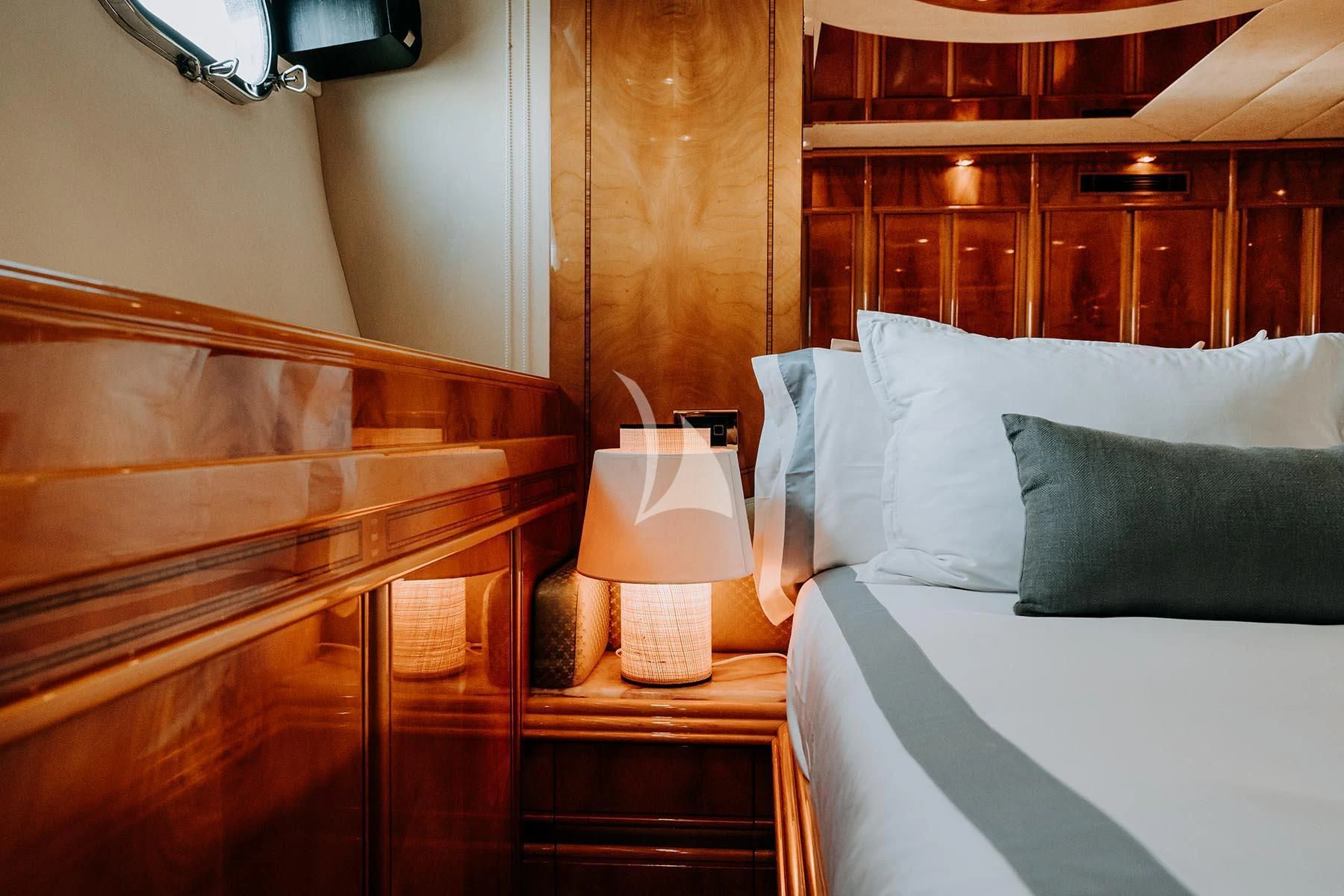 a bed with a lamp on it aboard SONRISA SEPTIMO Yacht for Sale