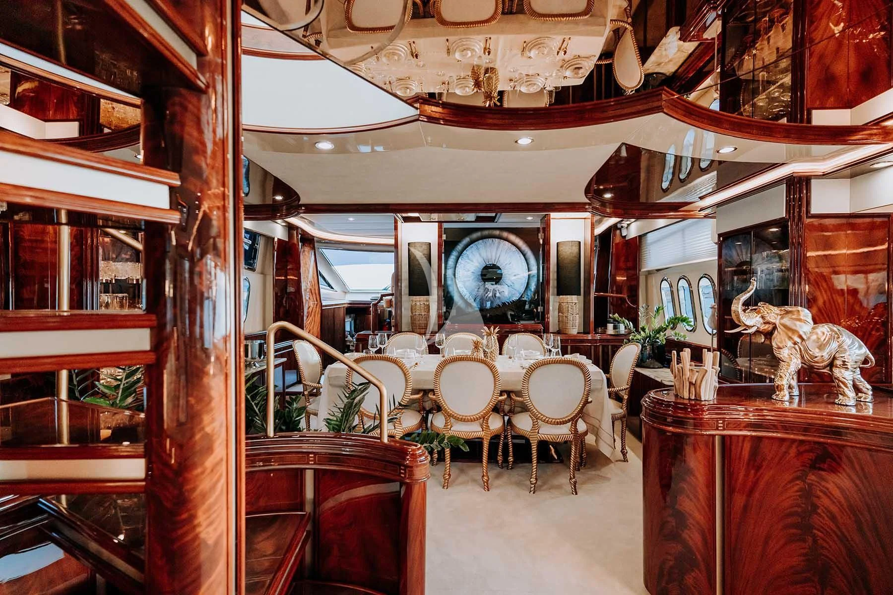a room with tables and chairs aboard SONRISA SEPTIMO Yacht for Sale