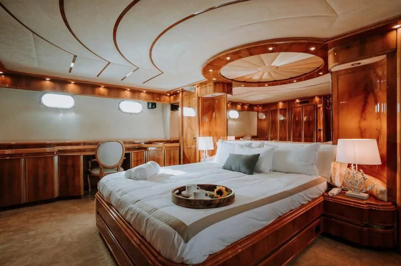 a large bed in a room aboard SONRISA SEPTIMO Yacht for Sale