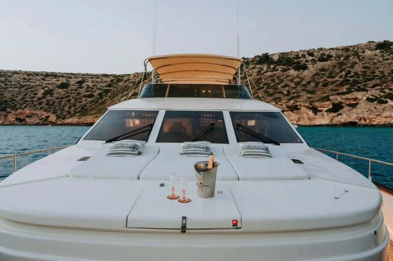 a white boat with a yellow and white canopy on it aboard SONRISA SEPTIMO Yacht for Sale